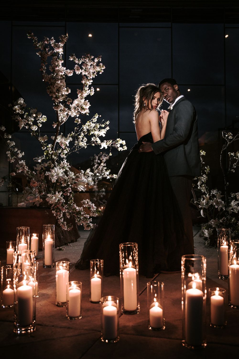 Black wedding dress surrounded by candles at the Natural History Museum in Utah.