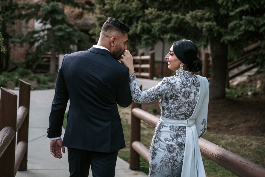 Bride and groom walking together through the courtyard at Stein Eriksen Lodge Deer Valley.